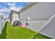 Side yard featuring artificial turf and a covered grill, perfect for outdoor cooking and relaxation at 744 Yukon Ln, Debary, FL 32713
