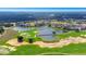 Scenic aerial shot of a neighborhood community featuring a golf course with ponds and lush green fairways at 7905 Jacks Club Dr, Kissimmee, FL 34747