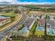 High aerial perspective of a home with a pool, adjacent to a golf course and roadway at 7905 Jacks Club Dr, Kissimmee, FL 34747