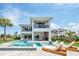Luxury two-story home showcases a private pool, spa, spacious patio and outdoor kitchen surrounded by lush landscaping at 7905 Jacks Club Dr, Kissimmee, FL 34747