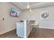 Modern bar area featuring a countertop, white bar stools, pendant lighting, and a mounted TV at 7905 Jacks Club Dr, Kissimmee, FL 34747