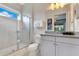 Bathroom featuring a glass enclosed shower, a white toilet, and a vanity with towels and toiletries at 7905 Jacks Club Dr, Kissimmee, FL 34747