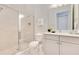 Bathroom featuring a glass-enclosed shower, white cabinets, and a marble countertop vanity at 7905 Jacks Club Dr, Kissimmee, FL 34747