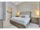 Bedroom showcasing a luxurious bed, walk-in closet, textured wall, and elegant decor at 7905 Jacks Club Dr, Kissimmee, FL 34747