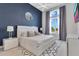 Comfortable bedroom with a large window, decorative rug, stylish furniture, and ample natural light at 7905 Jacks Club Dr, Kissimmee, FL 34747
