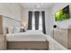 Bedroom featuring a neutral color scheme, plush bedding, dresser, and soft natural light at 7905 Jacks Club Dr, Kissimmee, FL 34747