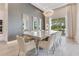 Elegant dining area featuring a glass-top table with seating for ten, modern lighting, and patterned wallpaper at 7905 Jacks Club Dr, Kissimmee, FL 34747