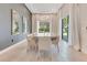 Dining room showcasing a large table, statement lighting, and outdoor views through large sliding glass doors at 7905 Jacks Club Dr, Kissimmee, FL 34747