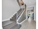 Grand entryway with wooden stairs, modern railings, tiled floors, and views of the pool and backyard at 7905 Jacks Club Dr, Kissimmee, FL 34747