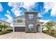 Beautiful two-story home featuring stone accents, manicured landscaping, and a spacious driveway at 7905 Jacks Club Dr, Kissimmee, FL 34747