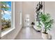 Bright foyer with soaring ceilings, modern art, and tiled floors at 7905 Jacks Club Dr, Kissimmee, FL 34747