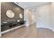 Modern hallway with geometric wallpaper, sleek desk, and minimalist decor for a sophisticated aesthetic at 7905 Jacks Club Dr, Kissimmee, FL 34747
