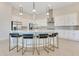 Modern kitchen with white cabinets, stainless steel appliances, and a large island with seating at 7905 Jacks Club Dr, Kissimmee, FL 34747