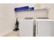 Bright laundry room with front-load Samsung washer and dryer and neatly organized shelf storage at 7905 Jacks Club Dr, Kissimmee, FL 34747