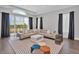 Comfortable living room with a large sectional sofa, stylish rug, and floor-to-ceiling windows providing natural light at 7905 Jacks Club Dr, Kissimmee, FL 34747