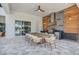 Outdoor dining area features a long table with seating and a fully equipped outdoor summer kitchen at 7905 Jacks Club Dr, Kissimmee, FL 34747