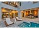 Well-designed backyard features a cozy outdoor living area, outdoor kitchen, and a pool with a spa at 7905 Jacks Club Dr, Kissimmee, FL 34747