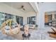 Elegant outdoor living area with a hanging chair, comfortable sofas, a fire pit, and an outdoor cooking area at 7905 Jacks Club Dr, Kissimmee, FL 34747