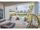 Outdoor living space featuring a pool, a fire pit, a hanging chair and outdoor sofas for elegant lounging at 7905 Jacks Club Dr, Kissimmee, FL 34747