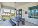 This recreation room features a combination ping pong and pool table, with seating, under a modern light fixture at 7905 Jacks Club Dr, Kissimmee, FL 34747