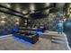 Home theater with tiered seating, a projector, a large screen, and stylish lighting and wallpaper at 7905 Jacks Club Dr, Kissimmee, FL 34747