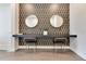 Modern vanity area with two chairs, stylish mirrors, geometric wallpaper and sleek design at 7905 Jacks Club Dr, Kissimmee, FL 34747