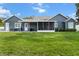 Expansive backyard view showcasing the patio, lush lawn, and well-maintained exterior of the home at 8717 Se 156Th St, Summerfield, FL 34491