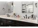 Double vanity bathroom features a modern white counter top, and sinks, and updated black fixtures at 8717 Se 156Th St, Summerfield, FL 34491