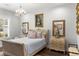 Comfortable bedroom features natural light, hardwood floors, and stylish traditional furnishings at 8717 Se 156Th St, Summerfield, FL 34491
