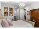 This bedroom features wood floors, elegant chandelier, and lots of wall decorations at 8717 Se 156Th St, Summerfield, FL 34491