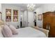 This bedroom features wood floors, elegant chandelier, and lots of wall decorations at 8717 Se 156Th St, Summerfield, FL 34491