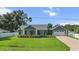 Charming home with beautiful landscaping, a well-manicured lawn, and an attached two-car garage at 8717 Se 156Th St, Summerfield, FL 34491