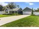 This single-Gathering home features an attached two-car garage, long driveway, and lawn at 8717 Se 156Th St, Summerfield, FL 34491