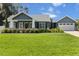 Charming home boasts lush landscaping, well-manicured lawn, and inviting curb appeal at 8717 Se 156Th St, Summerfield, FL 34491