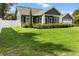 Well-manicured lawn and garden beds create a welcoming curb appeal for this lovely home at 8717 Se 156Th St, Summerfield, FL 34491