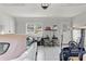 Clean and organized garage featuring epoxy flooring, ample storage, and space for vehicles at 8717 Se 156Th St, Summerfield, FL 34491