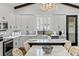 Well-lit kitchen boasts white cabinetry, marble countertops, and an adjacent dining area at 8717 Se 156Th St, Summerfield, FL 34491