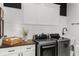 Well-lit laundry room with modern washer and dryer, white shiplap walls and storage at 8717 Se 156Th St, Summerfield, FL 34491