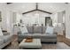 Open-concept living space seamlessly connects to kitchen under high ceilings with exposed beams at 8717 Se 156Th St, Summerfield, FL 34491
