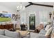 Spacious living room illuminated by elegant chandelier and natural light at 8717 Se 156Th St, Summerfield, FL 34491