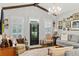 Bright, inviting living room features hardwood floors, statement lighting and decorative accessories at 8717 Se 156Th St, Summerfield, FL 34491