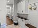 Organized mudroom with storage cabinets, butcher block countertop, hooks and bench seating at 8717 Se 156Th St, Summerfield, FL 34491
