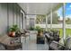 Comfortable screened patio featuring wicker furniture and peaceful backyard views at 8717 Se 156Th St, Summerfield, FL 34491