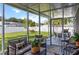 This patio is enclosed and features comfortable furniture, potted plants, and a view of the backyard at 8717 Se 156Th St, Summerfield, FL 34491