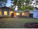 Charming home with stone accents, fresh landscaping, and warm lighting creating an inviting curb appeal at 8825 Larwin Ln, Orlando, FL 32817