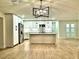 Bright kitchen with an island, stainless steel refrigerator, and pendant lighting at 8825 Larwin Ln, Orlando, FL 32817