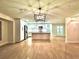 Open kitchen featuring stainless steel appliances, white cabinetry, and a large island at 8825 Larwin Ln, Orlando, FL 32817
