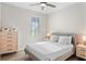 Bedroom with neutral tones, a large window, a comfortable bed, and minimalist furnishings at 8848 Bismarck Palm Dr, Winter Garden, FL 34787