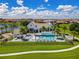 Aerial view of the community pool and clubhouse with palm trees and seating areas at 8848 Bismarck Palm Dr, Winter Garden, FL 34787