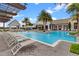 Spacious pool area with poolside seating and covered pergola for relaxing at 8848 Bismarck Palm Dr, Winter Garden, FL 34787